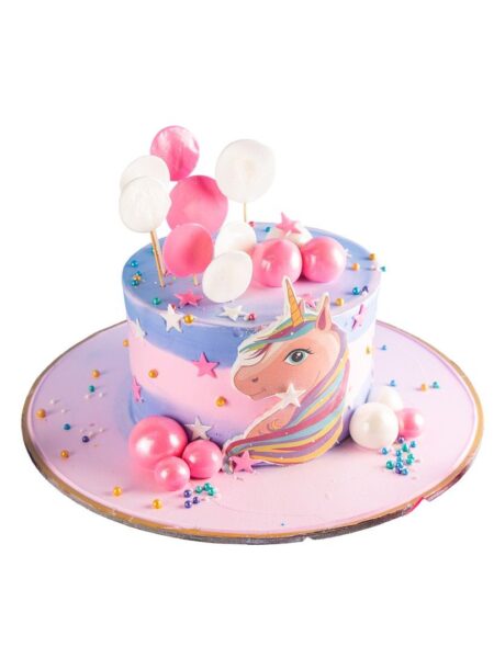 Unicorn cake with pastel colors, balloons, stars, and a rainbow-maned unicorn design.