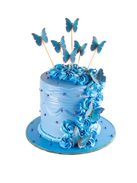Blue butterfly theme cake with elegant swirls, roses, and flying butterflies.