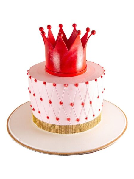 Red crown cake with quilted design, pearl accents, and a bold edible crown topper.