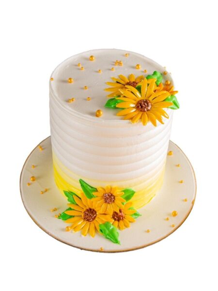 Elegant flower design cake with bright yellow sunflowers and green leaves.