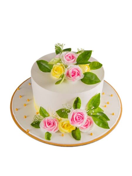 Elegant floral cake decorated with pink and yellow roses, green leaves, and golden pearls.