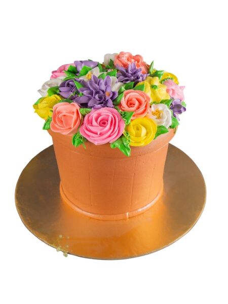 Flower vase cake designed as a pot filled with colorful buttercream roses and blossoms.