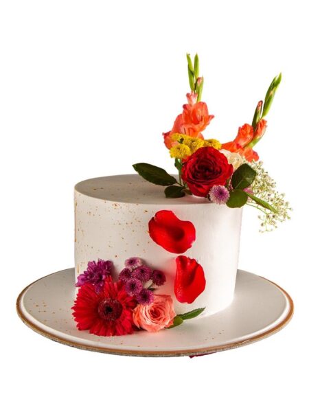 Elegant flower cake with red roses, vibrant blooms, and fresh floral decorations.
