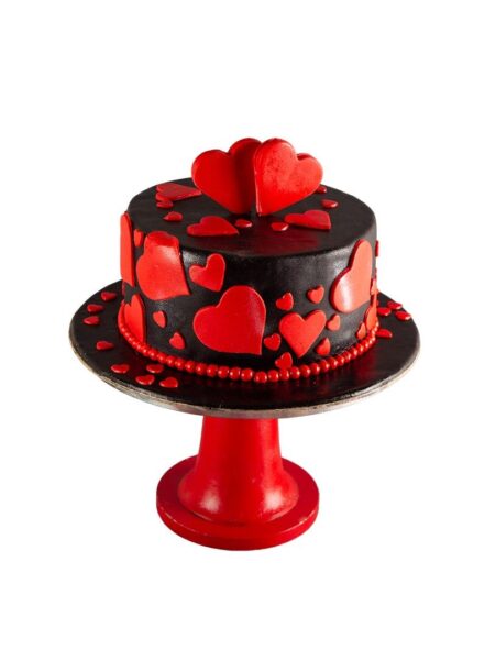 Two hearts cake with bold red hearts on black frosting, accented with pearls and heart confetti.