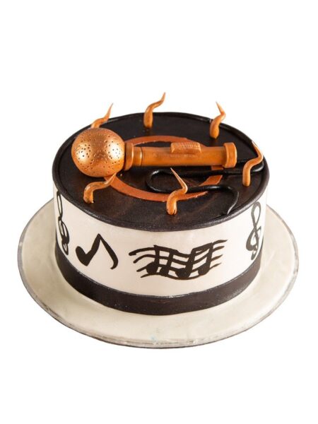 Super singer theme cake with edible golden microphone, music notes, and black-and-white design.
