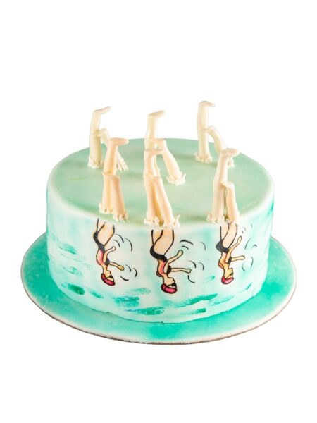 Synchronized swimming cake with edible swimmer legs, water design, and aquatic theme.