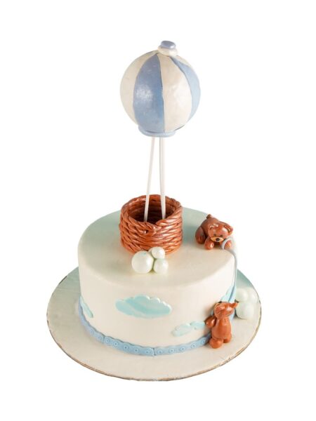 Winnie the Pooh theme cake with hot air balloon, teddy bears, clouds, and playful décor.